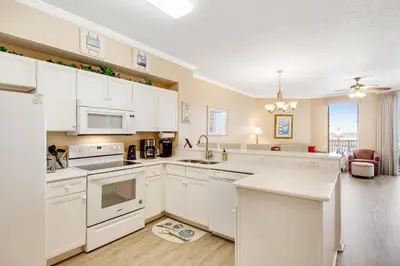 a kitchen with white cabinets and a white counter top at Charming suite with spacious balcony pools tennis & pickleball in Santa Rosa Beach