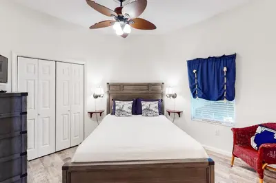 a bedroom with a bed and a ceiling fan at Dog-friendly 4th-floor 3-bedroom condo with stunning Gulf views & pickleball in Santa Rosa Beach