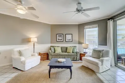 a living room with two couches and a table at Two-bedroom with bunks balcony overlooking pool & on-site pickleball in Santa Rosa Beach