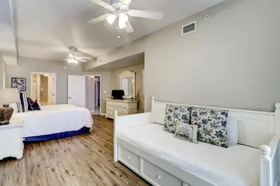 a bedroom with two beds and a ceiling fan at Two-bedroom with bunks balcony overlooking pool & on-site pickleball in Santa Rosa Beach