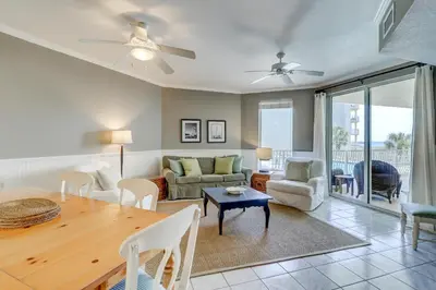 a living room with a table and a couch at Two-bedroom with bunks balcony overlooking pool & on-site pickleball in Santa Rosa Beach