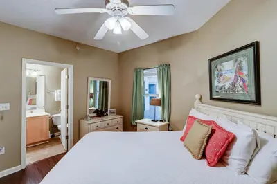 a bedroom with a white bed and a ceiling fan at Gorgeous 3-bedroom condo with stunning view spacious balcony & pickleball in Santa Rosa Beach
