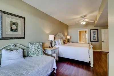 a bedroom with two beds and a ceiling fan at Gorgeous 3-bedroom condo with stunning view spacious balcony & pickleball in Santa Rosa Beach