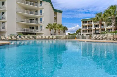 a large swimming pool in front of a building at Charming two-bedroom with bunks balcony overlooking pool & pickleball in Santa Rosa Beach