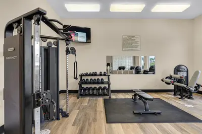 a gym with treadmills and machines in a room at Charming two-bedroom with bunks balcony overlooking pool & pickleball in Santa Rosa Beach