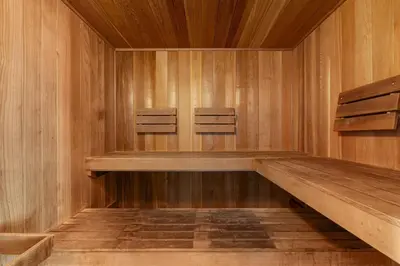 a sauna with wooden walls and two chairs in it at Amazing views at this renovated 4rth-floor condo with lagoon pool & pickleball in Santa Rosa Beach