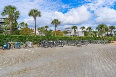 a row of bikes parked in a parking lot at Gorgeous condo with pool & Gulf view stunning decor bunk beds & pickleball in Santa Rosa Beach