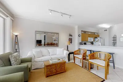 a living room with a couch and a table at Super-comfy Seagrove condo with spacious pool-view balcony & pickleball in Santa Rosa Beach