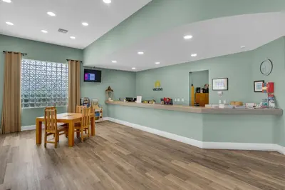a waiting room at a pharmacy with a table and chairs at Bright Gulf-view condo with balcony pool seasonal beach service & pickleball in Santa Rosa Beach