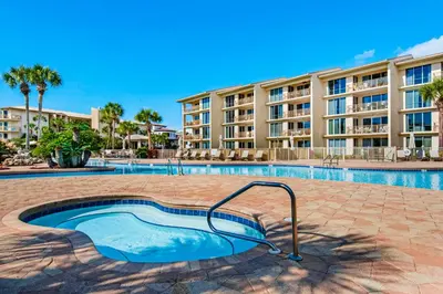 a swimming pool in front of a apartment building at Amazing Santa Rosa Beach condo with pool hot tub & pickleball in Seacrest