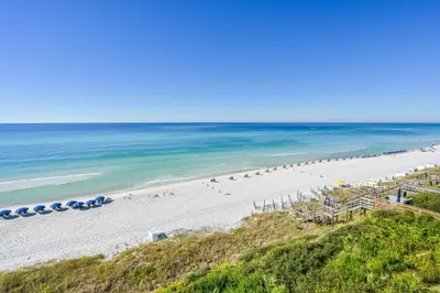 an aerial view of a beach with umbrellas and the ocean at Amazing Santa Rosa Beach condo with pool hot tub & pickleball in Seacrest