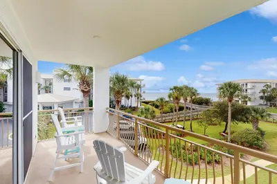 a balcony with chairs and a view of the ocean at Amazing High Pointe condo with grill hot tub pool tennis & pickleball in Seacrest