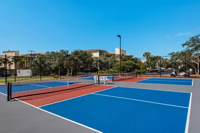 a tennis court with two tennis courts at Spacious getaway with Gulf view beach access tennis & pickleball in Seacrest