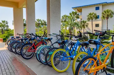 a row of bikes parked next to a building at Conveniently located Gulf condo with spacious layout pool & pickleball in Seacrest