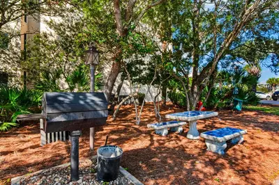 a park with a piano and a picnic table at Condo with pickleball - steps from the Gulf & quick walk to dining & shops in Seacrest