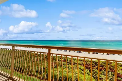 a balcony with a view of the beach and the ocean at Gulf-front condo with bicycles lazy river & pickleball in Seacrest