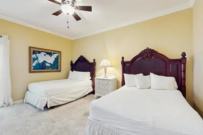 a bedroom with two beds and a ceiling fan at Elegant getaway with stunning view lagoon pool & pickleball - close to shops in Seacrest