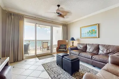 a living room with a couch and a view of the ocean at Elegant getaway with stunning view lagoon pool & pickleball - close to shops in Seacrest