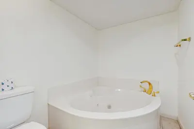 a white bathroom with a sink and a toilet at Gorgeous beach condo with furnished balcony panoramic view & pickleball in Seacrest