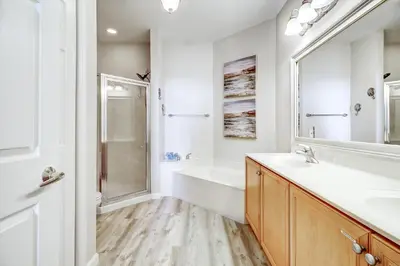 a bathroom with a tub and a sink and a shower at Beautiful 2nd-floor condo in Seagrove Beach with beach ambience & pickleball in Santa Rosa Beach