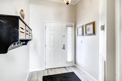a hallway with a white door and a black rug at Beautiful 2nd-floor condo in Seagrove Beach with beach ambience & pickleball in Santa Rosa Beach