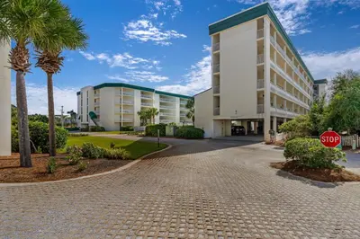 a stop sign in front of a building at Beautiful 2nd-floor condo in Seagrove Beach with beach ambience & pickleball in Santa Rosa Beach