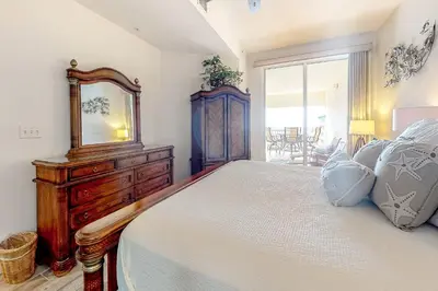 a bedroom with a bed and a dresser and a mirror at Lovely home with pool & Gulf views covered parking bikes & pickleball in Santa Rosa Beach