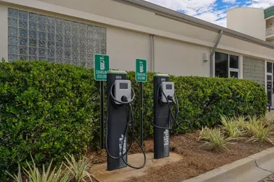 a row of parking meters in front of a building at Lovely home with pool & Gulf views covered parking bikes & pickleball in Santa Rosa Beach