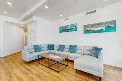 a living room with a couch and a table at Gulf-front view & spacious condo with wraparound balcony & pickleball in Santa Rosa Beach