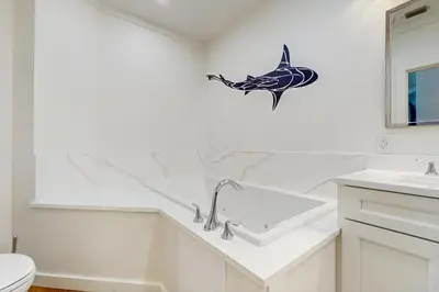 a bathroom with a dolphin decal on the wall at Gulf-front view & spacious condo with wraparound balcony & pickleball in Santa Rosa Beach
