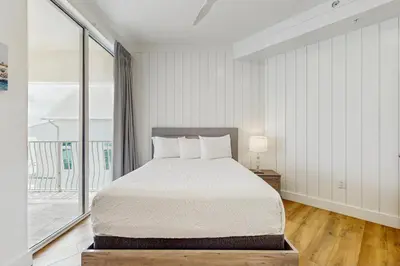 a bedroom with a bed and a large window at Gulf-front view & spacious condo with wraparound balcony & pickleball in Santa Rosa Beach