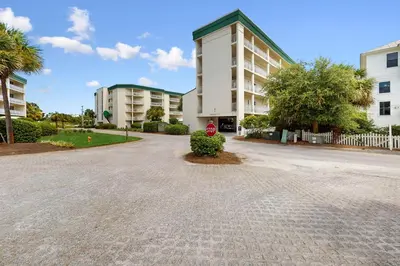 a building with a red stop sign in a driveway at Gulf-front view & spacious condo with wraparound balcony & pickleball in Santa Rosa Beach
