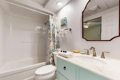 a bathroom with a sink and a toilet and a mirror at Beachfront condo with 2 beach chairs included & pickleball - short walk to dining in Seacrest