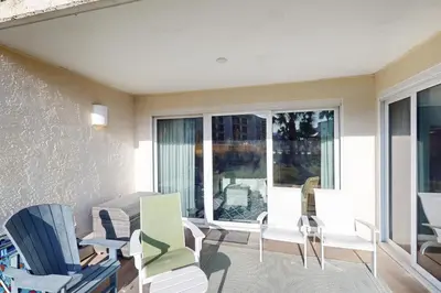 a living room with chairs and a large window at Beachfront condo with 2 beach chairs included & pickleball - short walk to dining in Seacrest