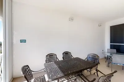 a table and chairs in a room with a window at Magical 3rd-floor condo with pools telescope for stargazing & pickleball in Santa Rosa Beach