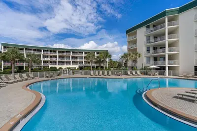 a swimming pool in front of a resort at Magical 3rd-floor condo with pools telescope for stargazing & pickleball in Santa Rosa Beach