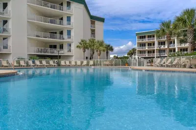 a large swimming pool in front of a building at Magical 3rd-floor condo with pools telescope for stargazing & pickleball in Santa Rosa Beach