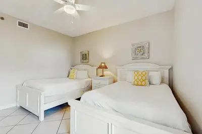 a bedroom with two beds and a ceiling fan at Coastal condo with lagoon pool bike rentals tennis pickleball & beach access in Seacrest