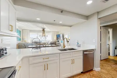 a kitchen with white cabinets and a sink at Beach dwelling with great view pool & pickleball - snowbird-friendly in Seacrest
