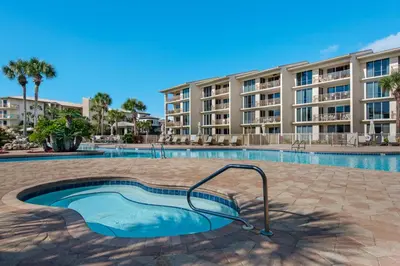 a swimming pool in front of a apartment building at Condo on the beach with tennis pickleball shuffleboard & balcony in Seacrest