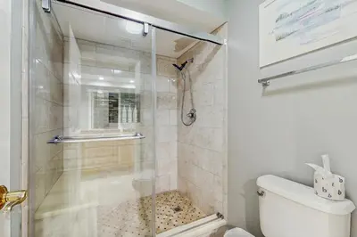 a bathroom with a shower with a glass door at Gorgeous home with tennis pickleball pool & hot tub - steps from the beach in Seacrest