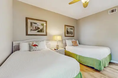 a bedroom with two beds and a ceiling fan at Gorgeous home with tennis pickleball pool & hot tub - steps from the beach in Seacrest