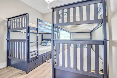 a bunk bed room with two bunk beds at Sleek beach-themed retreat with patio bikes LSV & pool access in Inlet Beach