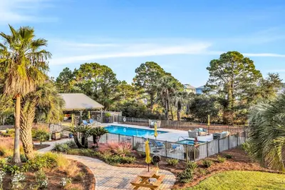 an estate with a swimming pool and palm trees at Beachview studio with full kitchen shared pool and beach access in Santa Rosa Beach