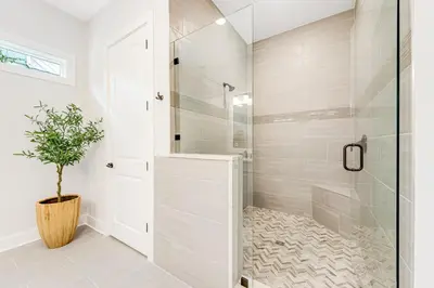 a bathroom with a shower and a potted plant at Dog-friendly home with community pool flat top grill and custom coffee bar in Rosemary Beach
