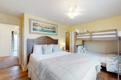a bedroom with two beds and a bunk bed at Dog-friendly beachfront townhouse with balcony 2 bikes W&D in Rosemary Beach