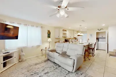 a living room with a couch and a table at Dog-friendly beachfront townhouse with balcony 2 bikes W&D in Rosemary Beach