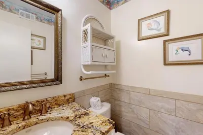 a bathroom with a sink and a mirror and a toilet at Dog-friendly beachfront townhouse with balcony 2 bikes W&D in Rosemary Beach