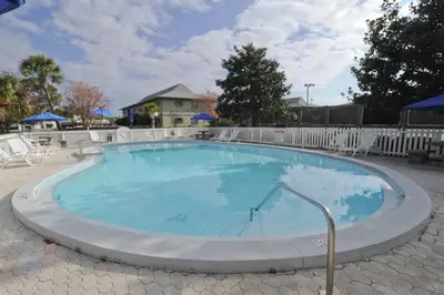 a large swimming pool with blue water at Cute ground floor condo with shared pool access to shuffleboard and tennis in Santa Rosa Beach