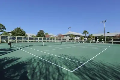 a tennis court with a tennis racket on it at Cute ground floor condo with shared pool access to shuffleboard and tennis in Santa Rosa Beach